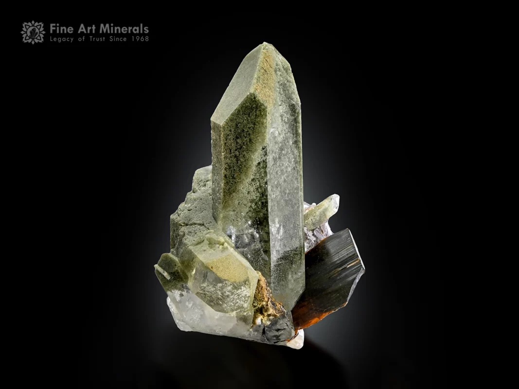 Brookite crystal associated with elongated chlorite-included quartz with sharp termination and natural contrast.