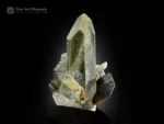 Brookite crystal associated with elongated chlorite-included quartz with sharp termination and natural contrast.