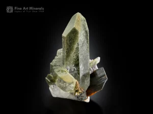 Brookite crystal associated with elongated chlorite-included quartz with sharp termination and natural contrast.