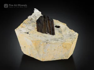 Thick brookite crystal on matrix with small quartz crystals from Pakistan.