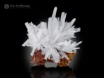 White calcite crystal cluster with sharp terminations on a brown matrix.