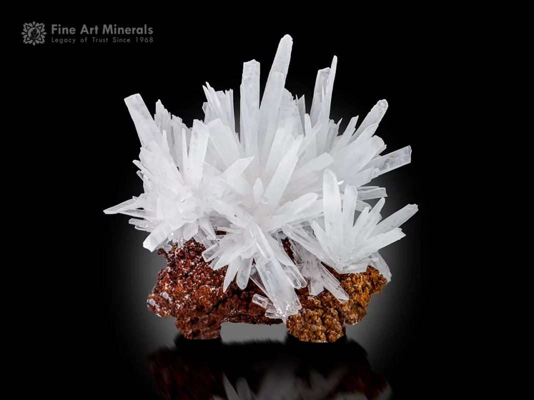 White calcite crystal cluster with sharp terminations on a brown matrix.