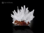 White calcite crystal cluster with sharp terminations on a brown matrix.