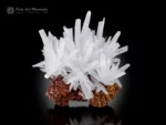 White calcite crystal cluster with sharp terminations on a brown matrix.