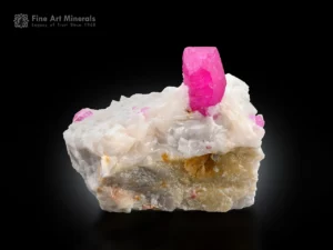 Ruby crystal on matrix glowing under UV light fluorescent corundum specimen.