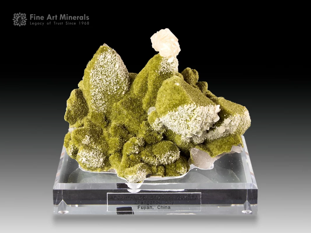Green epidote specimen with moss-like texture and apophyllite crystal on top