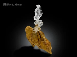 Faden Quartz specimen with sharp crystals and internal faden structure on earthy matrix.