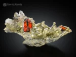 Fiery red Brookite crystal with phantom inclusions on a chlorite-coated quartz matrix with sparkling crystals.