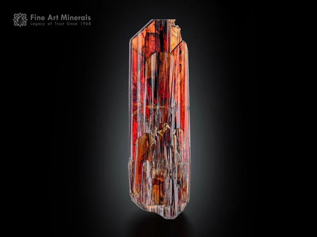 Elongated fiery red brookite crystal with phantom inclusions and sharp termination.