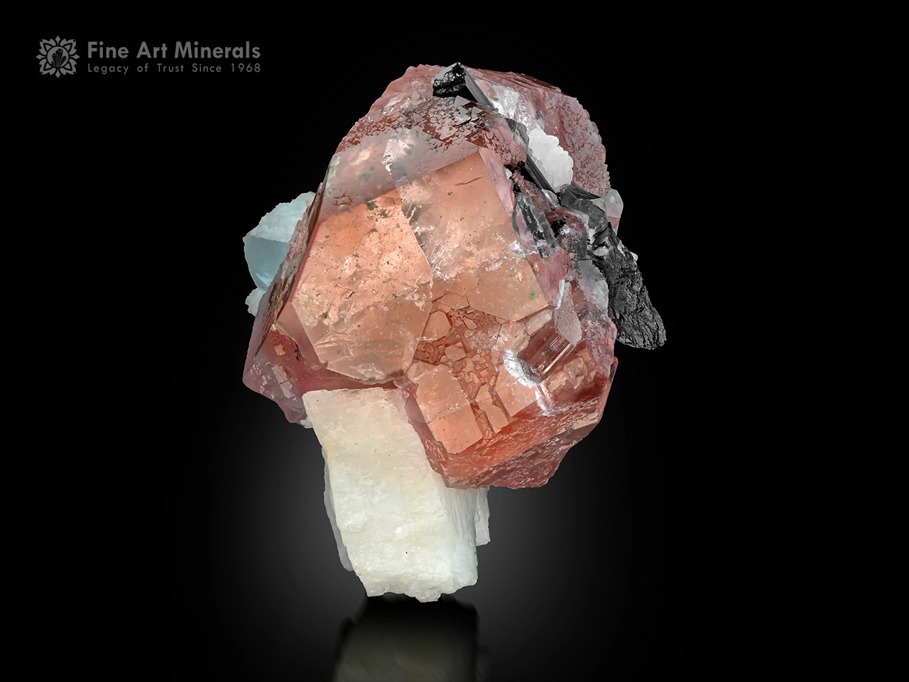 Pink fluorite crystal with aquamarine schorl and feldspar matrix from Pakistan.