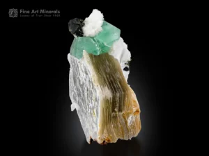 Green fluorite crystal with black tourmaline and muscovite on white albite matrix.