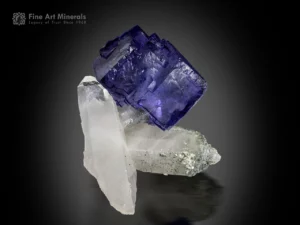 Cubic fluorite crystal on quartz matrix with strong color contrast from Yaogangxian, China.