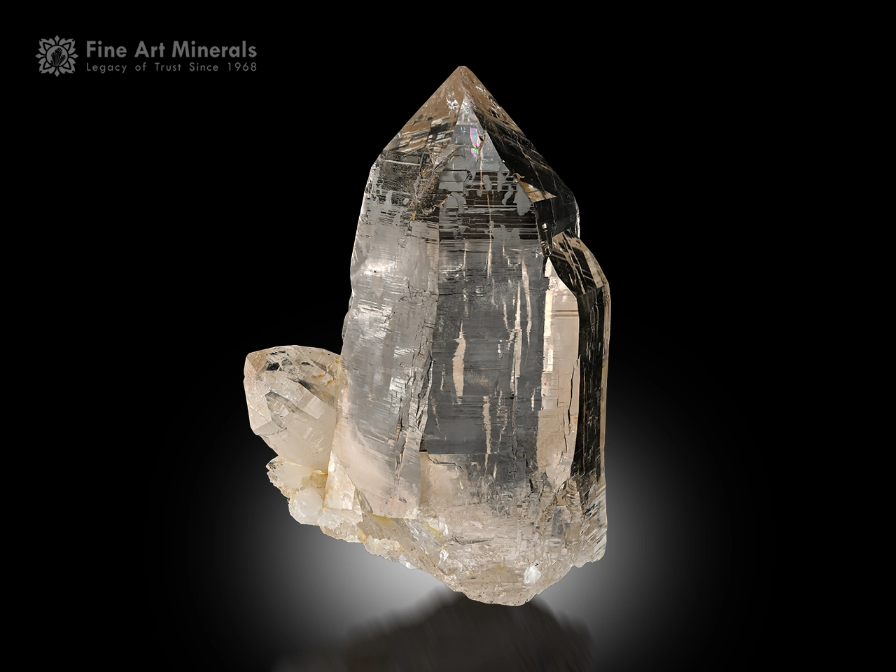 Clear quartz crystal with a subtle smoky hue and sharp termination