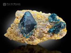 Deep blue lazulite crystal on a light matrix, showing a wedge-shaped form and strong contrast.