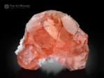 Intense pink fluorite crystals with transparency and sculptural form on subtle albite from Chumar Bakhoor, Pakistan.