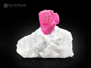 Ruby crystal on white matrix glowing under UV fluorescent corundum specimen