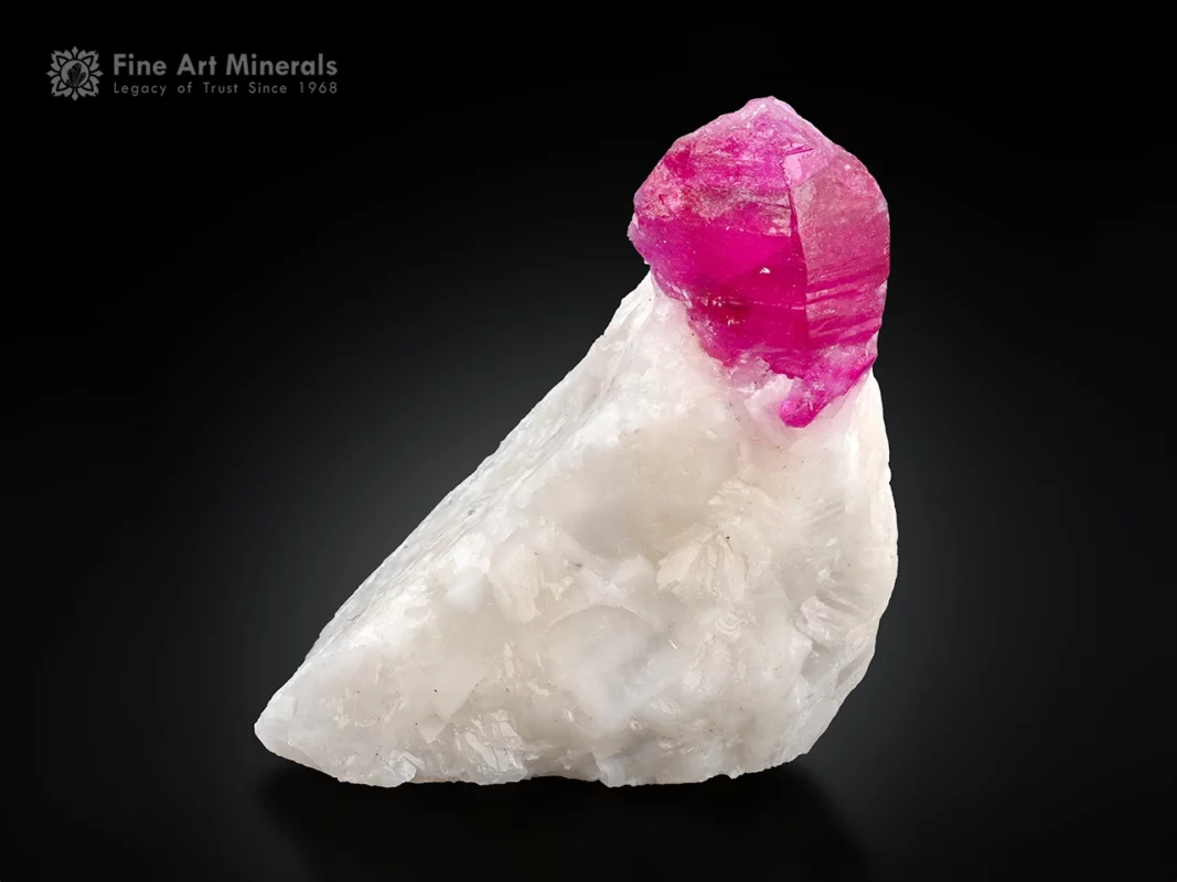 Sharply terminated ruby crystal on white matrix fluorescent corundum specimen.