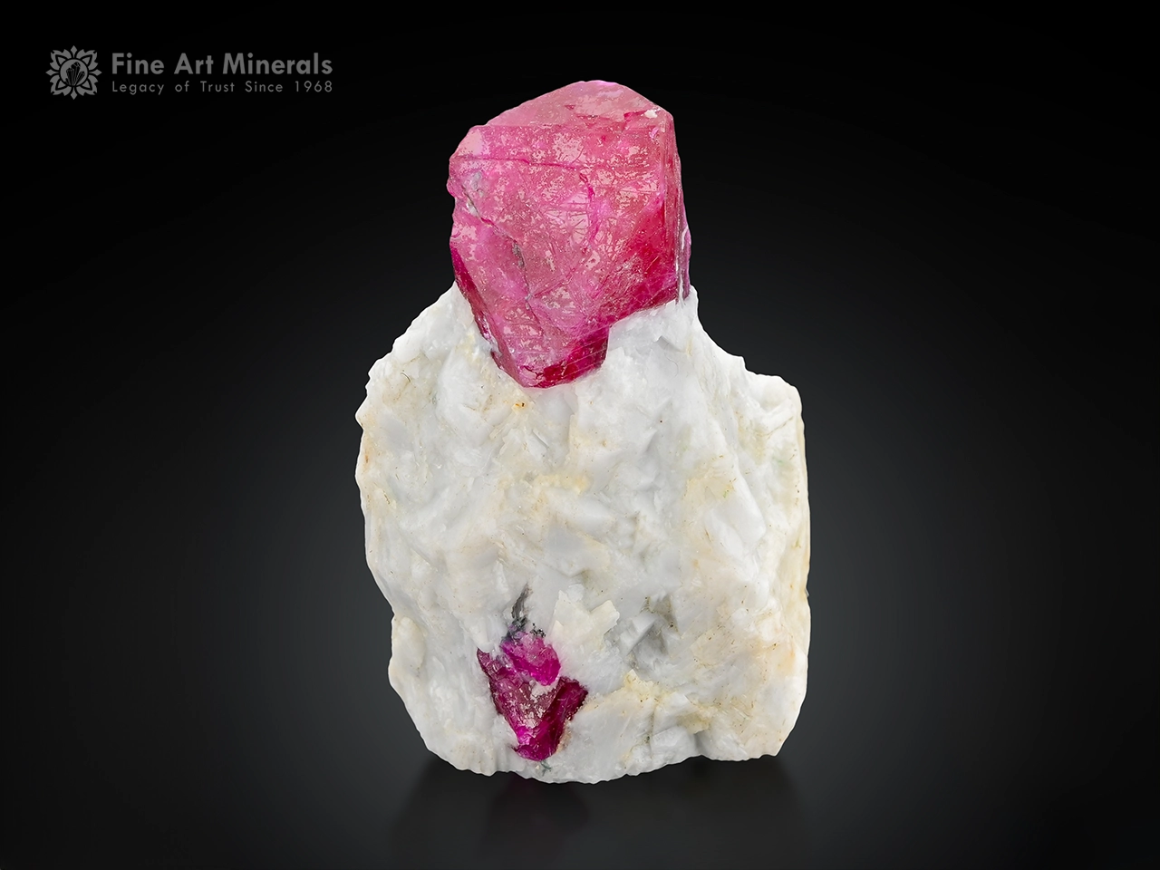 Ruby crystal on white matrix glowing under UV fluorescent corundum specimen.