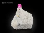 Ruby crystal on white matrix with pyrite fluorescent corundum specimen.