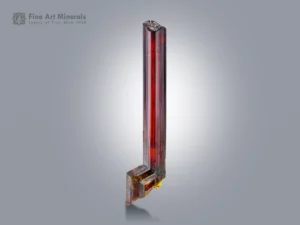 Elongated rutile crystal with red glow from Zagi Mountain, Pakistan.