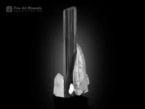Long black schorl tourmaline crystal with vertical striations on quartz matrix with subtle albite.