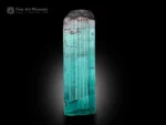 Blue seafoam tourmaline crystal with a pink hue at termination and strong striations.