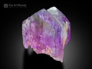 Lavender kunzite crystal with double growth and vertical striations showing a subtle green tint.