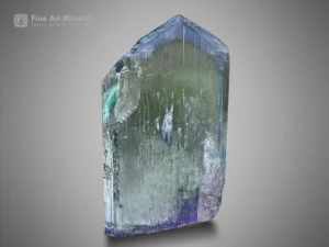 Spodumene var. kunzite crystal with blue and green color zoning and vertical striations.