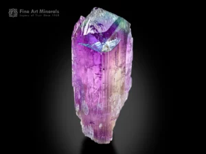 Spodumene var. kunzite crystal showing purple and green hues with etched termination.