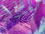 Spodumene var. kunzite crystal showing purple and green hues with etched termination.