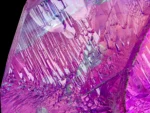 Spodumene var. kunzite crystal showing purple and green hues with etched termination.