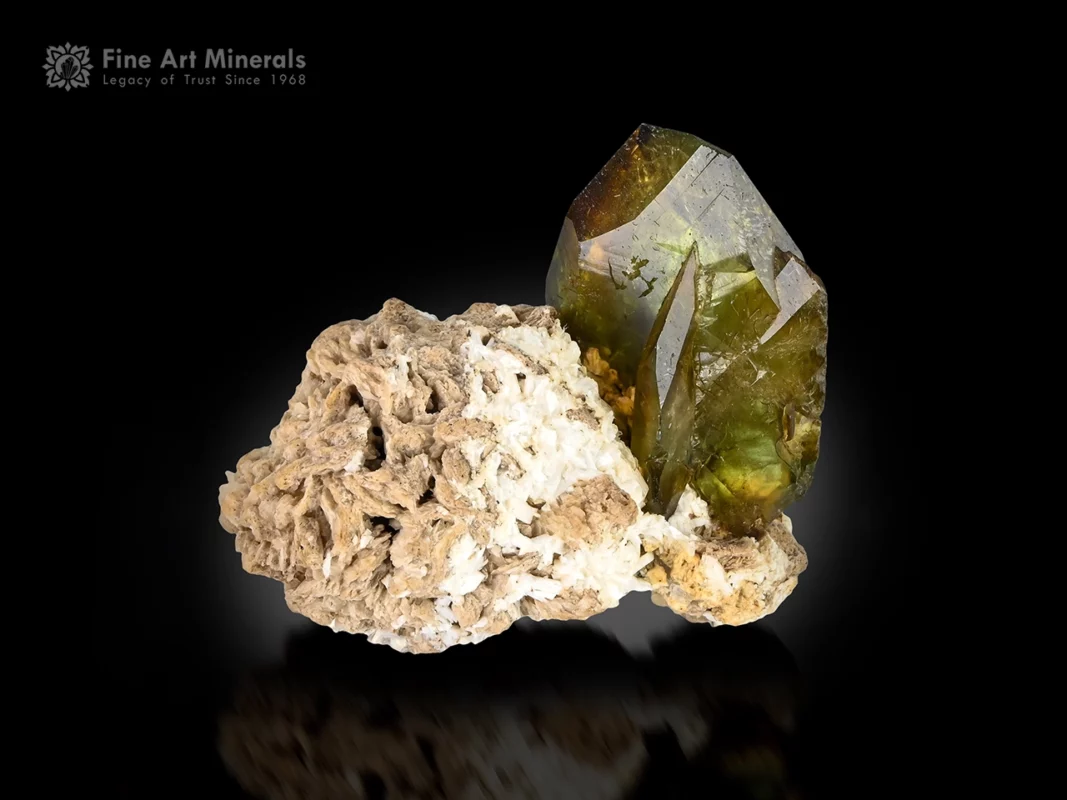 Well-terminated titanite crystal with green and golden tones on white albite matrix.