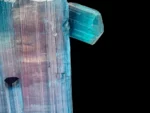 Tourmaline crystal with pink and blue-green color zoning and side crystals.