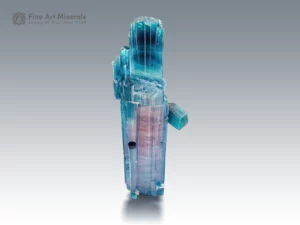 Tourmaline crystal with pink and blue-green color zoning and side crystals.