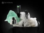 Tourmaline crystals with green fluorite on white feldspar matrix, mineral specimen.