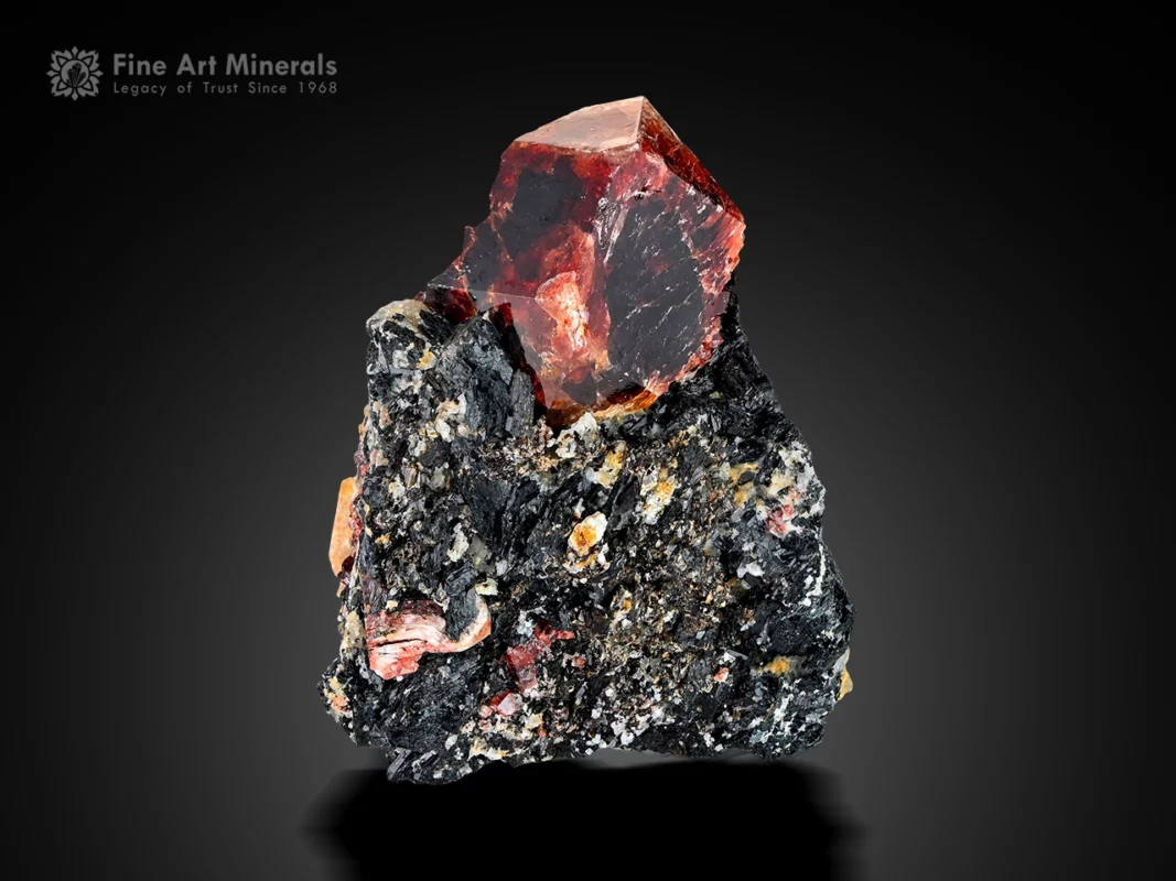 zircon crystal on dark matrix, red color, sharp geometry, strong luster, specimen