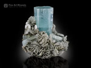 Sky-blue aquamarine crystal on muscovite matrix with smaller associated crystals from Nagar Valley.