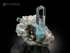 Blue aquamarine crystal with sharp termination on albite and quartz matrix.