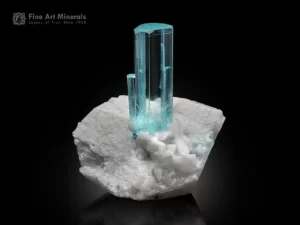 Pristine gem-quality aquamarine crystal with superb clarity and hexagonal shape on white feldspar matrix.