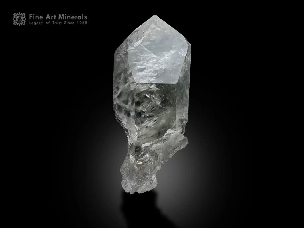 Quartz crystal with chlorite and Byssolite inclusions and glassy luster.