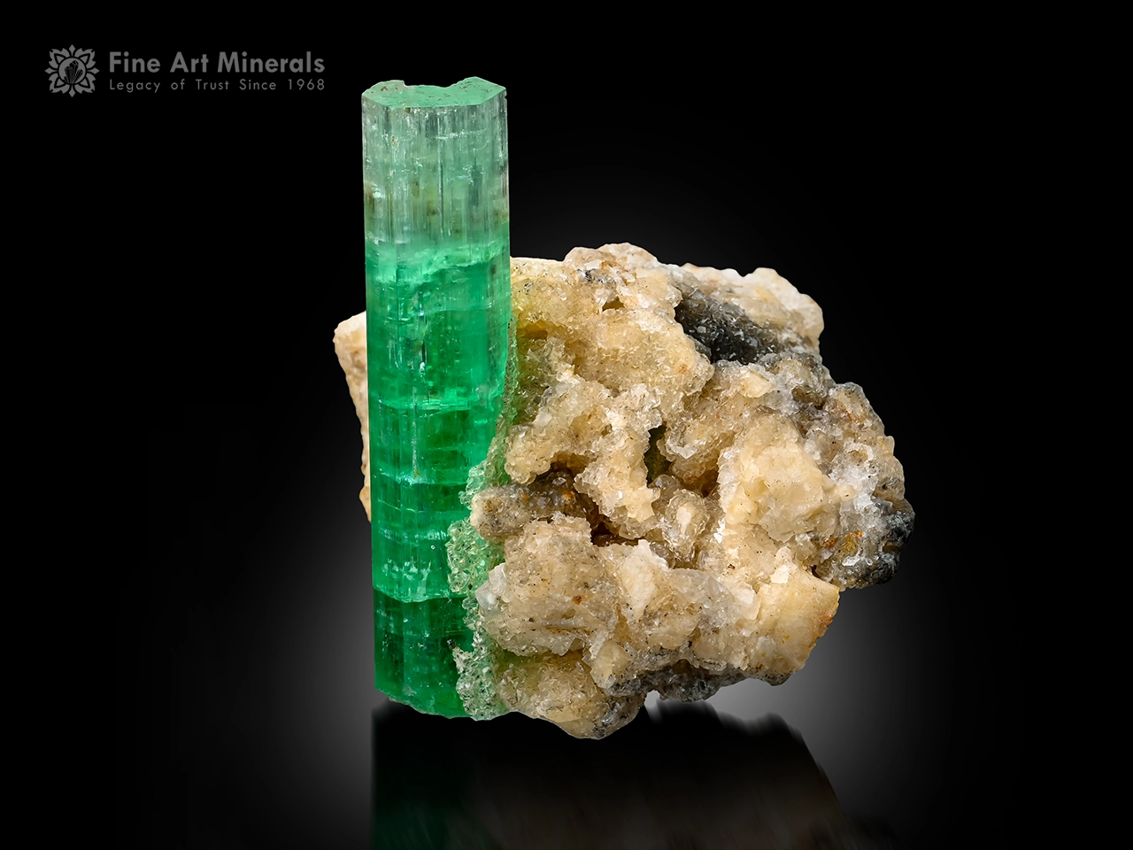 Green emerald crystal on albite matrix showing hexagonal form and fluorescence under UV light.