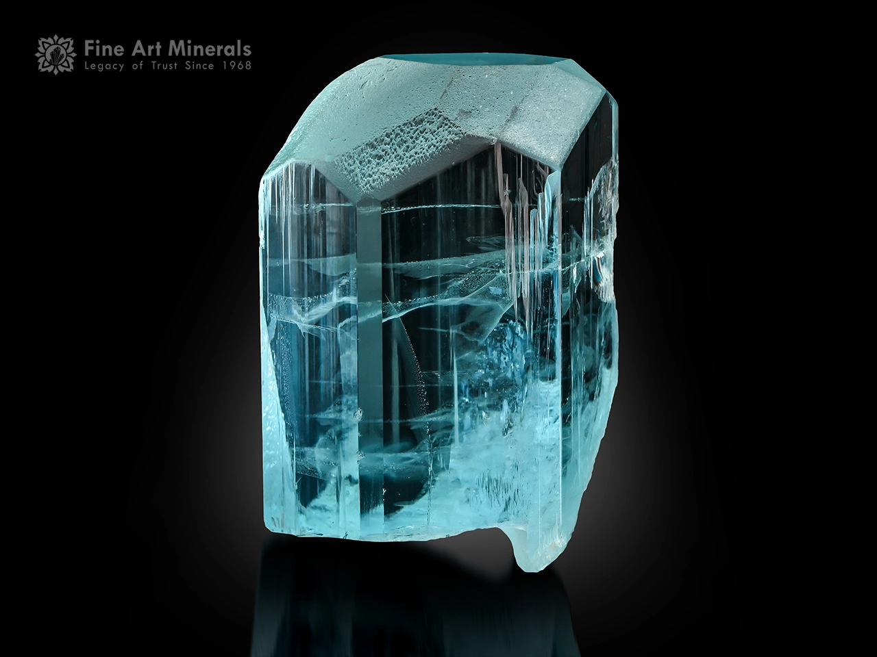 Transparent aquamarine crystal with etched termination and glassy luster