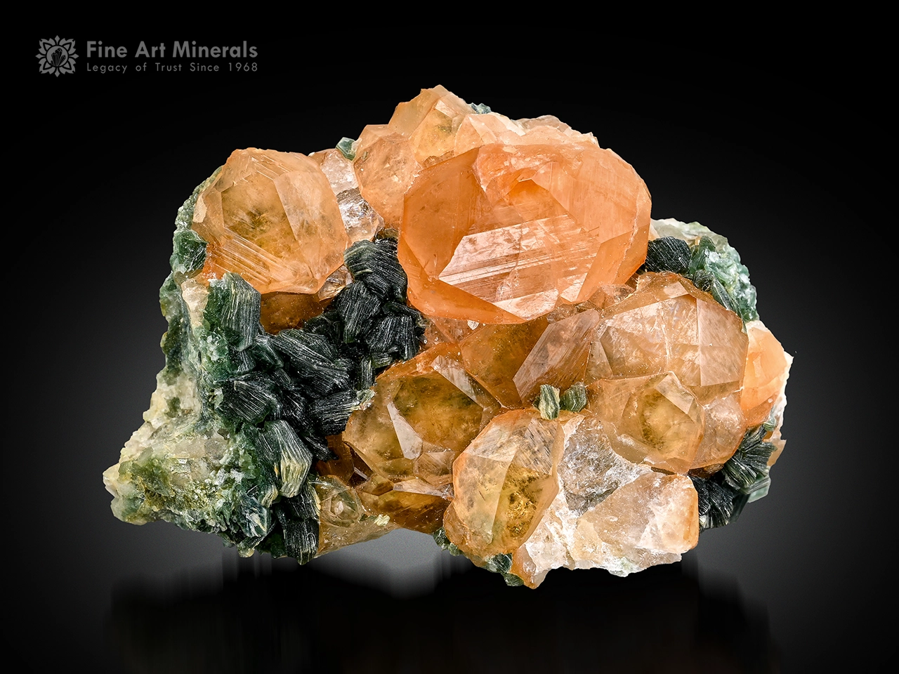 Honey orange hessonite garnet crystals with green muscovite on matrix from Pakistan