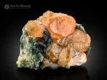 Honey orange hessonite garnet crystals with green muscovite on matrix from Pakistan