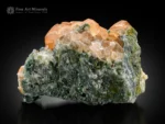 Honey orange hessonite garnet crystals with green muscovite on matrix from Pakistan