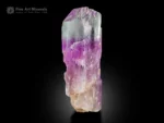 Kunzite crystal from Afghanistan with lilac color, natural colorless zones, and superb luster displayed against a black background
