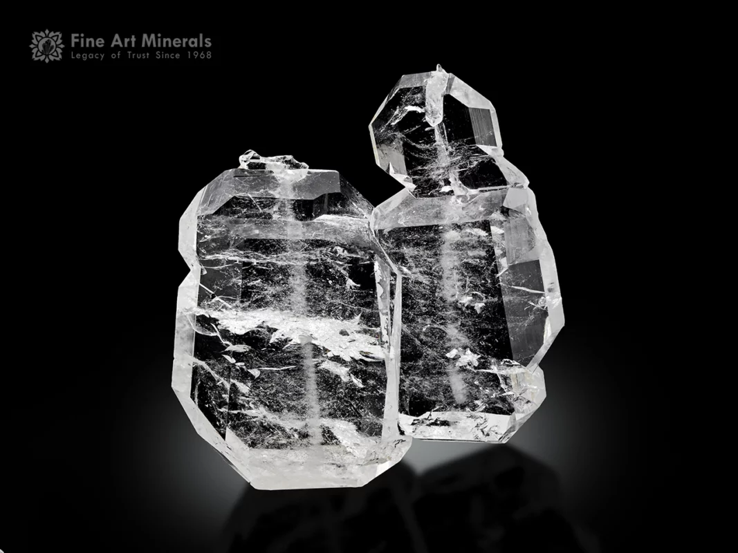 Clear parallel-grown faden quartz crystals with visible internal threads and sharp terminations.