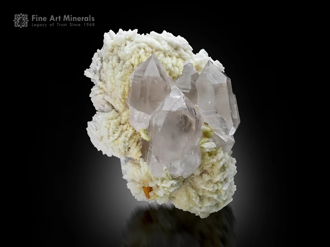 Quartz crystal cluster on albite matrix with embedded microlite crystal showing sharp terminations and good luster.