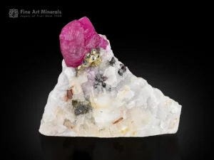 Natural Ruby crystal with Pyrite on white matrix showing strong fluorescence under UV light.