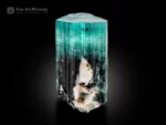 Tourmaline crystal with seafoam blue top transitioning to dark base, flat termination, vertical striations and albite.